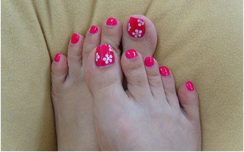Cinco flores de puntos en las uñas del dedo del pie